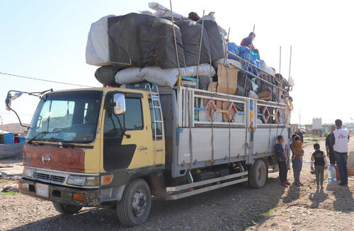 Laylan camp: trucks for belongings Laylan camp: trucks for belongings