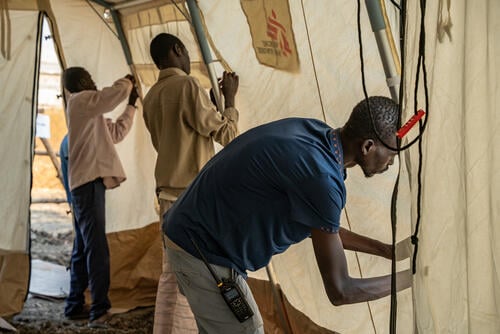 MSF staff setting up a CTC tent MSF staff setting up a CTC tent